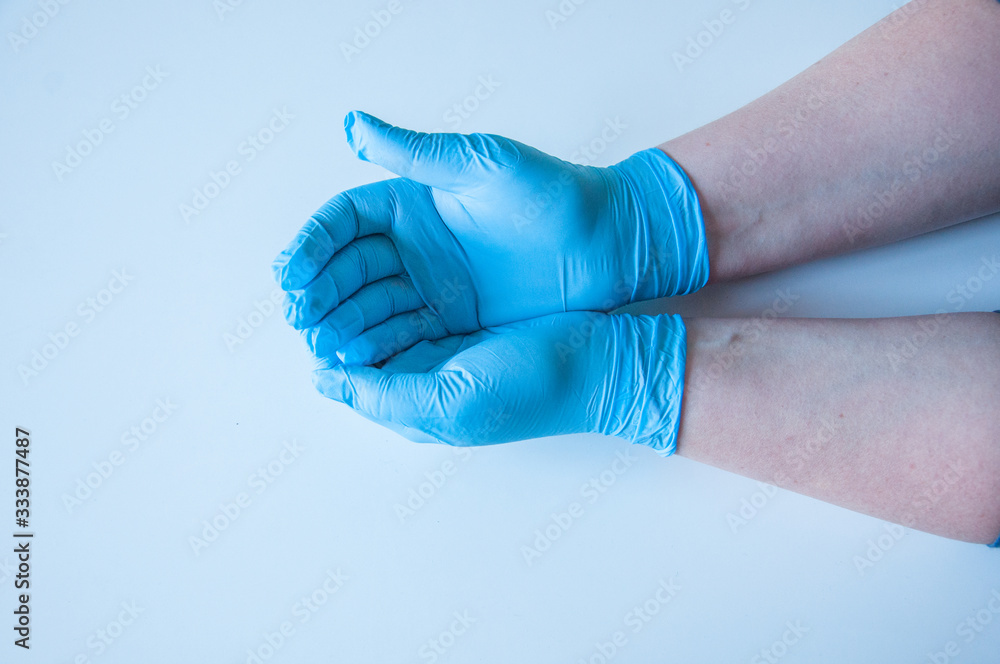 Doctor wears medical gloves. Blue latex medical gloves on a woman's hand, o