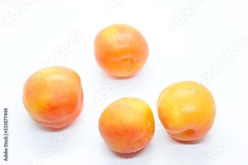 Inculate ripe plums located on a white background