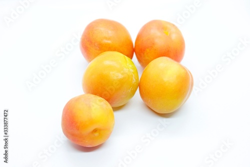 Inculate ripe plums located on a white background