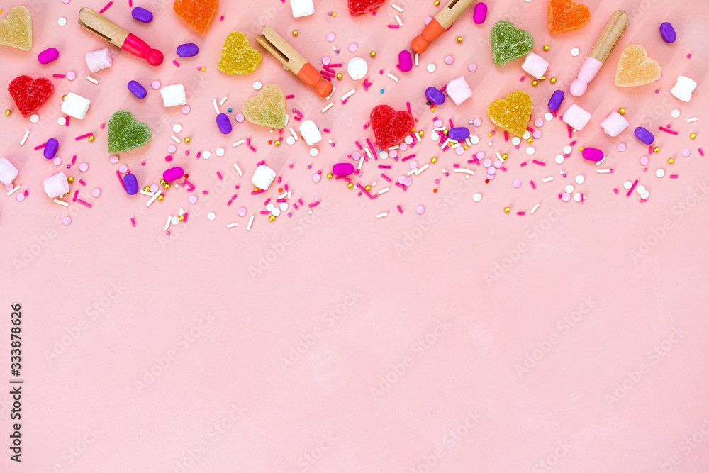Top view decoration assorted gummy candies and jelly sweets happy holiday background concept. Flat lay colorful candy on beautiful pink desk. Copy space.