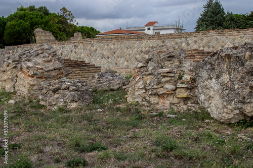 Larino, Campobasso, Roman archaeological site on the modern building background, on a sunny day