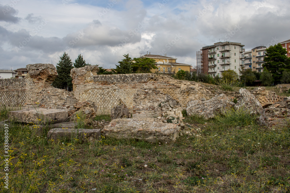 Larino, Campobasso, Roman archaeological site on the modern building background, on a sunny day