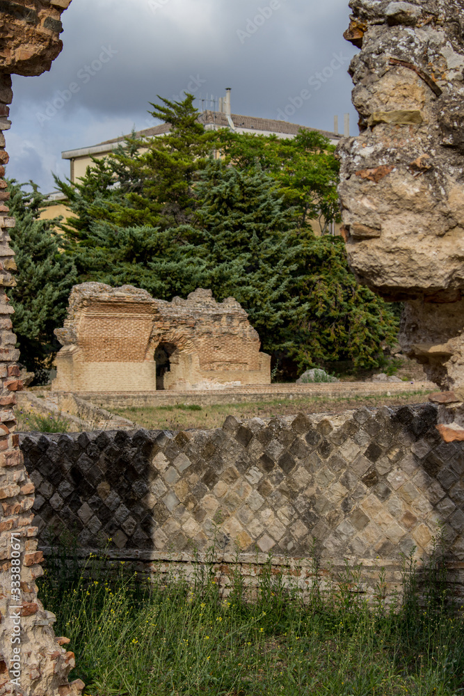 Larino, Campobasso, Roman archaeological site on the modern building background, on a sunny day