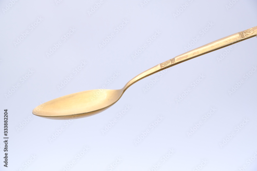 Golden spoon isolated on white background Golden spoon isolated on white background