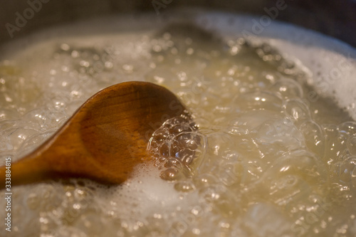boiling water for pasta with wooden spoon