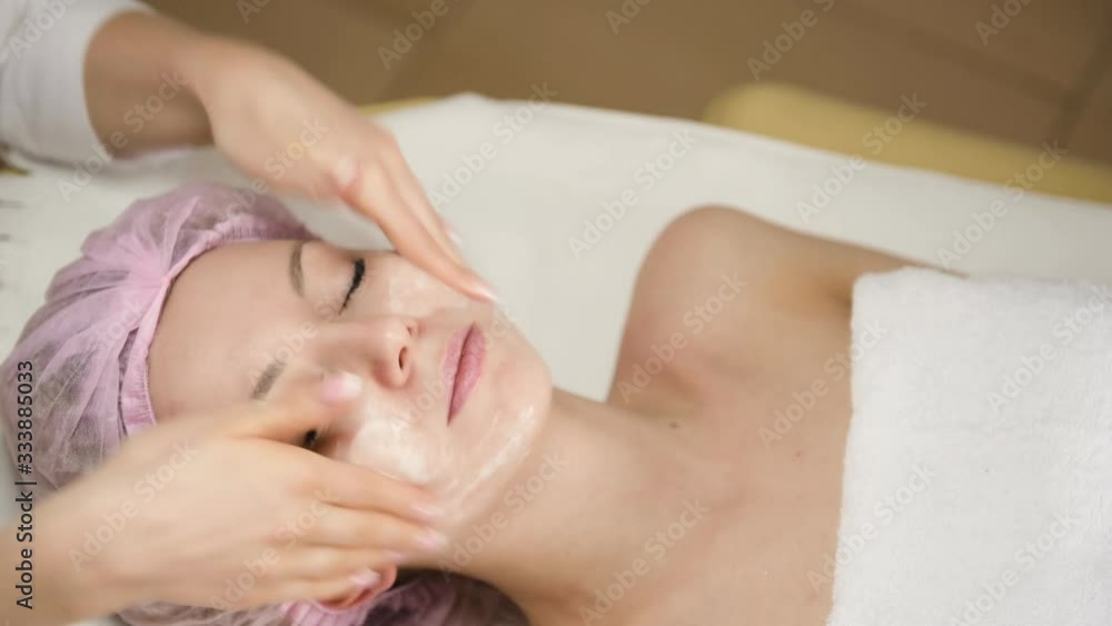 girl doctor cosmetologist washes the girl's face, close-up girl doctor cosmetologist washes the girl's face, close-up