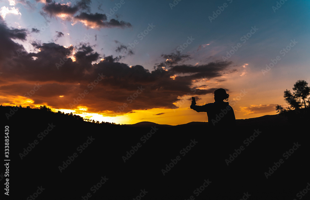 Fototapeta premium taking photograph of sunset