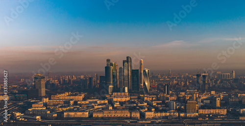 Moscow city at dawn in the orange rays of the sun aerial view.