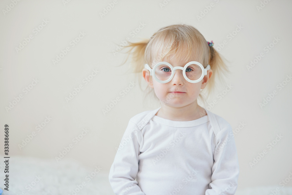 Cute joyful baby girl in funny toy glasses. Cute joyful baby girl in funny toy glasses.