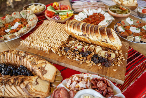 Tableau sur toile Fresh baked sweet bread and autumn nuts and apples surrounded by traditional foo