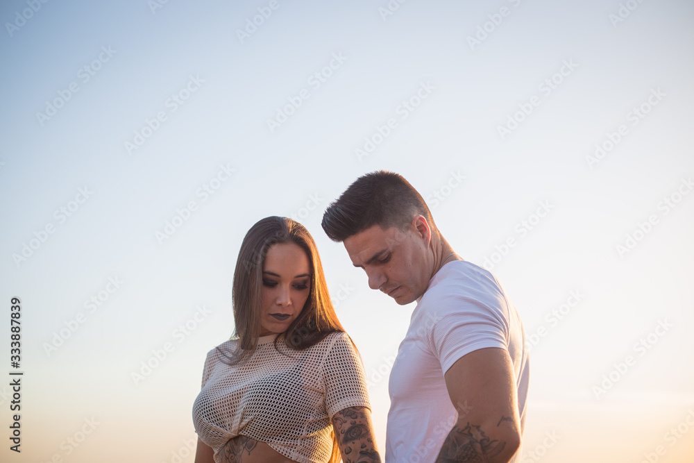 Couple enjoying a summer afternoon with a sunset Couple enjoying a summer afternoon with a sunset