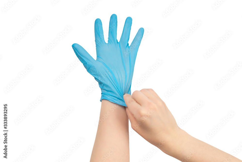 Woman puts on blue rubber gloves. Woman puts on blue rubber gloves.