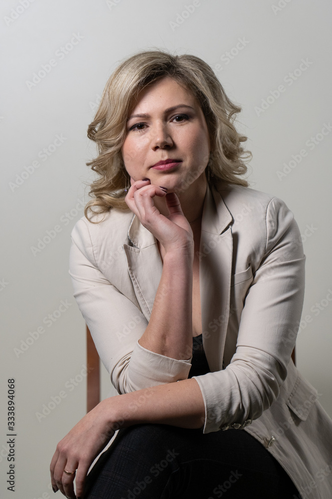 woman with blond hair posing on a white background