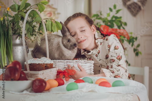 little girl with rabbit  in the kitchen,  Easter holiday