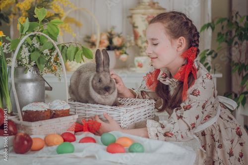 little girl with rabbit  in the kitchen,  Easter holiday