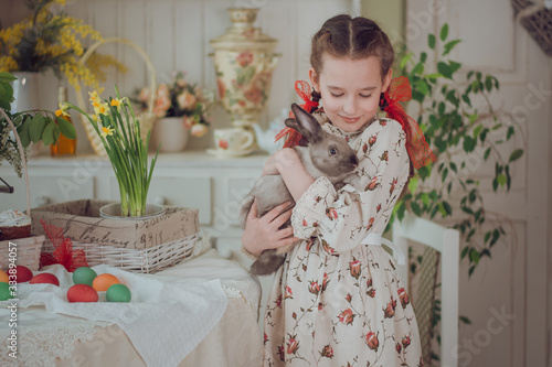 little girl with rabbit  in the kitchen,  Easter holiday