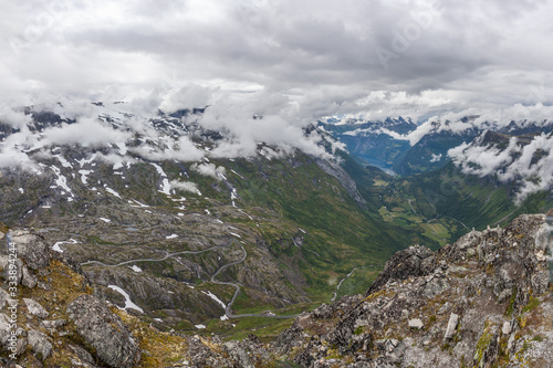 Beautiful view to the Atlantic ocean - Geiranger fjord and eagle road in cloudy weather from Dalsnibba mountain, Norway, selective focus.