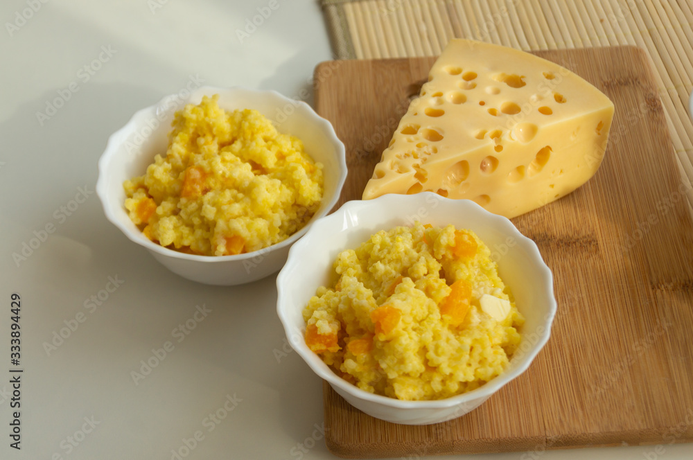 millet porridge with pumpkin and cheese on the table millet porridge with pumpkin and cheese on the table