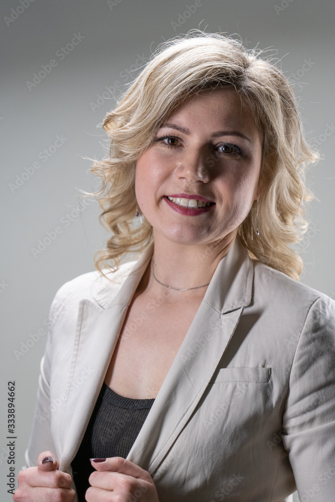 woman 30 years old with blond hair posing on a white background