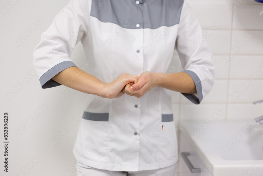 The doctor disinfects the hands. The doctor washes his hands with soap and treats with an antiseptic The doctor disinfects the hands. The doctor washes his hands with soap and treats with an antiseptic