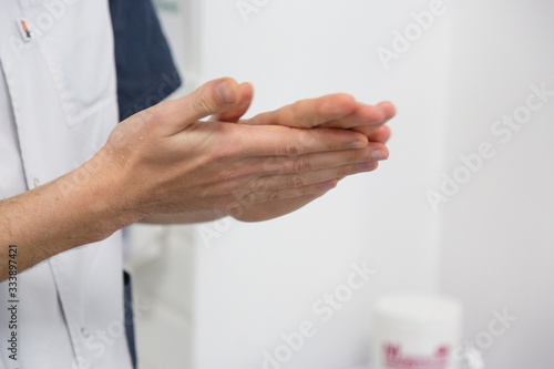 The doctor disinfects the hands. The doctor washes his hands with soap and treats with an antiseptic