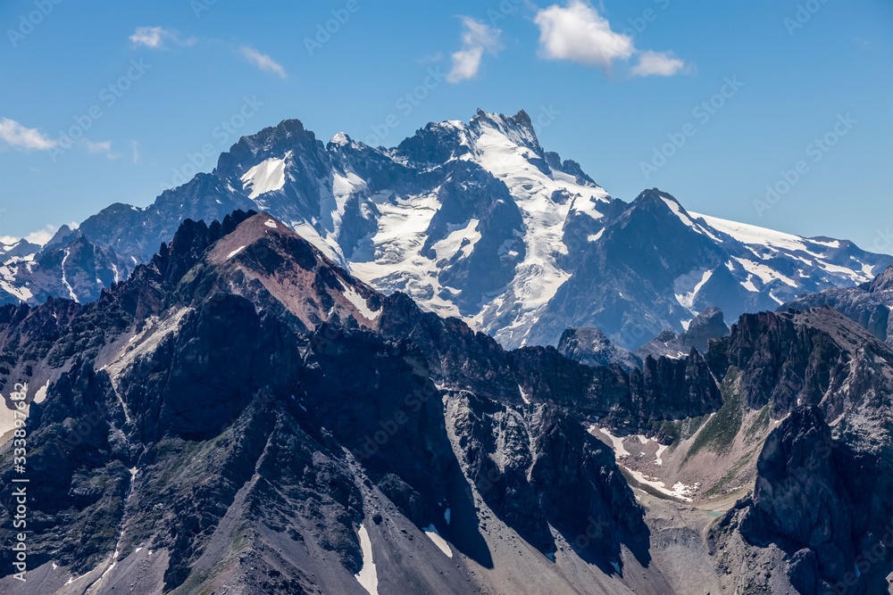 High altitude landscape in Alps with snowcapped peaks seen from Etroite Valley in Massif des Cerces in Hautes Alps in France.