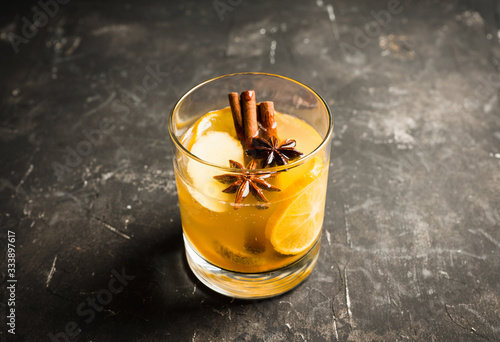 Fototapeta Naklejka Na Ścianę i Meble -  Healthy hot beverage with lemon, ginger and spices for protection in flu season. Selective focus. Shallow depth of field.