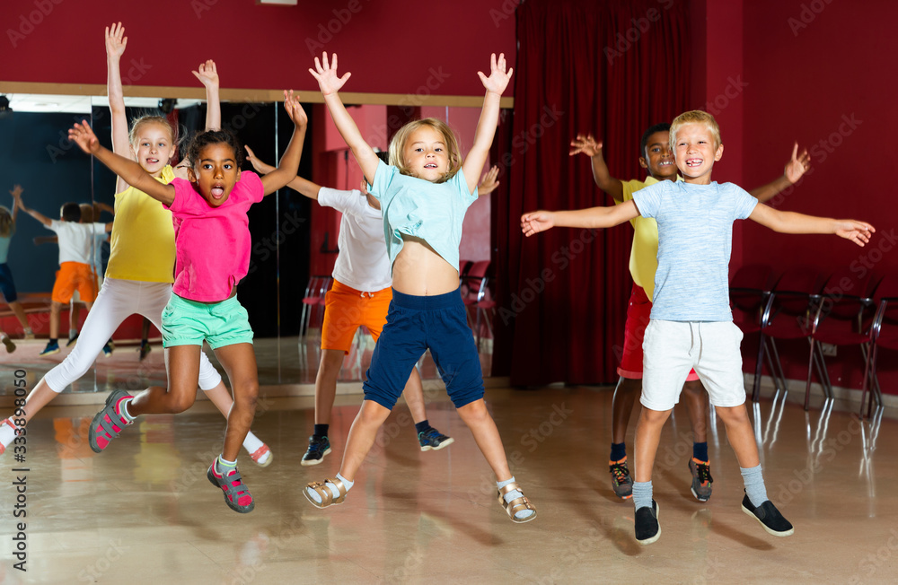 Positive children jumping while studying dance