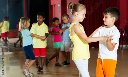 Fototapeta Naklejka Na Ścianę i Meble -  Group of happy children dancing salsa dance