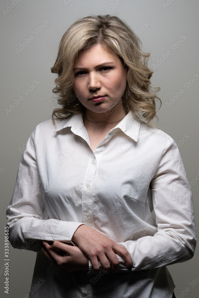 30 years old woman with blond hair in a white shirt posing