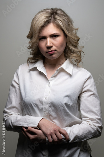 30 years old woman with blond hair in a white shirt posing