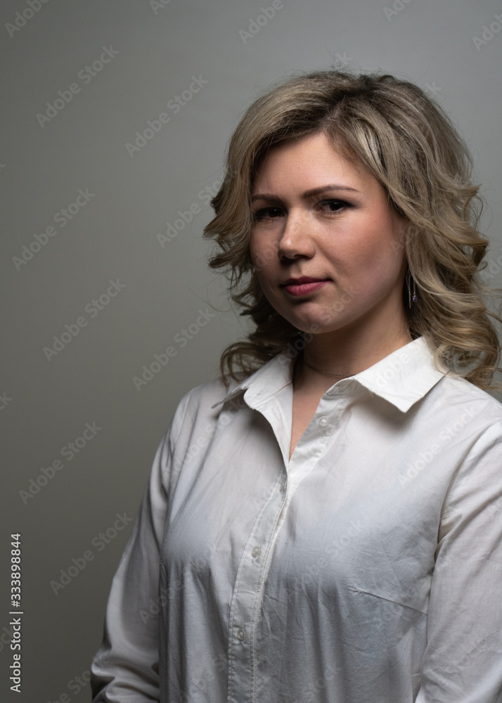 30 years old woman with blond hair in a white shirt posing