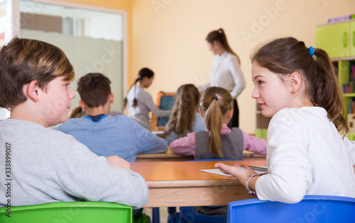 Schoolchildren chatting during lesson