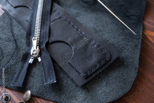 Genuine Leather. Sewing a purse. Leather work. Tools for sewing bags, wallets, clutches. Stitching. Manual sewing of the product. The manufacture of leather products.