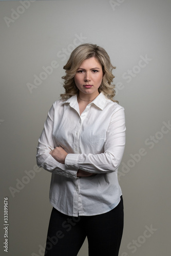 30 years old woman with blond hair in a white shirt posing