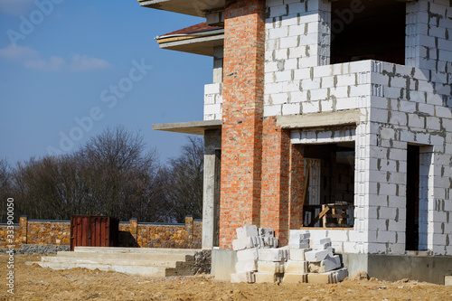 construction of a country two-story house from a gas block photo