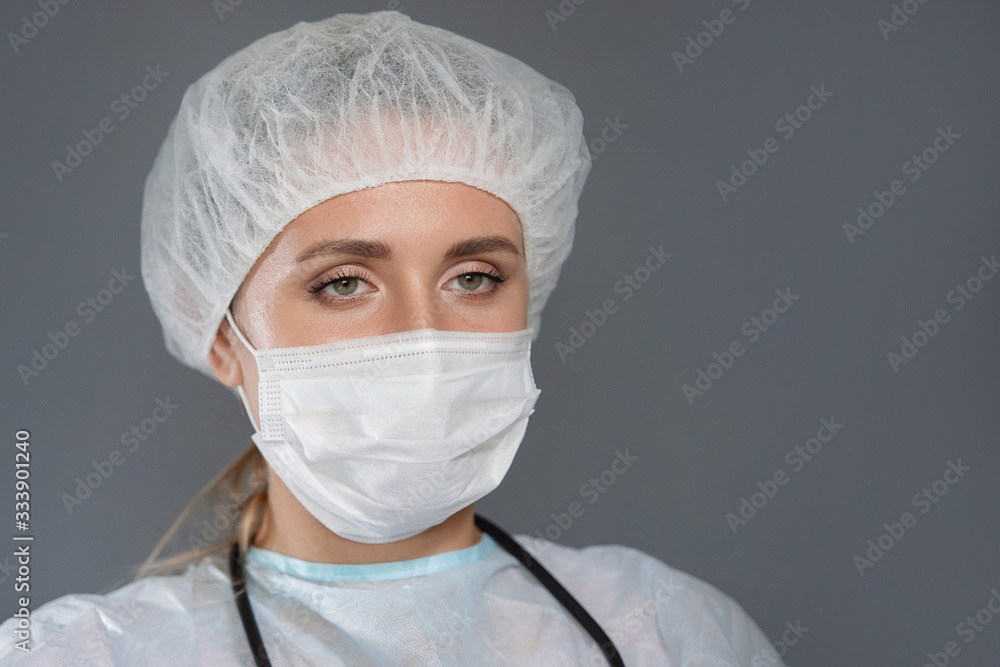 Nurse with phonendoscope, mask and cap.