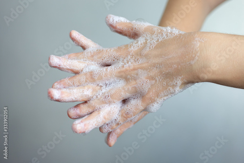 Washing hands with foamy soap, protection against coronavirus. Close up