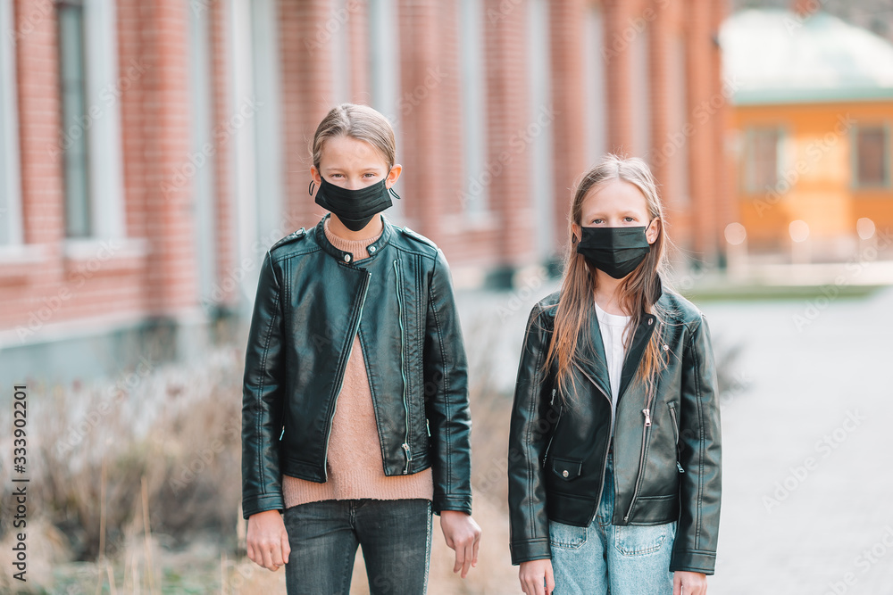 Girls wearing a mask on a background of a modern building,