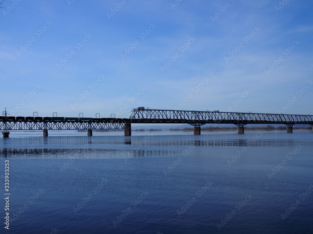 Railway bridge over the river. Sunny spring day.