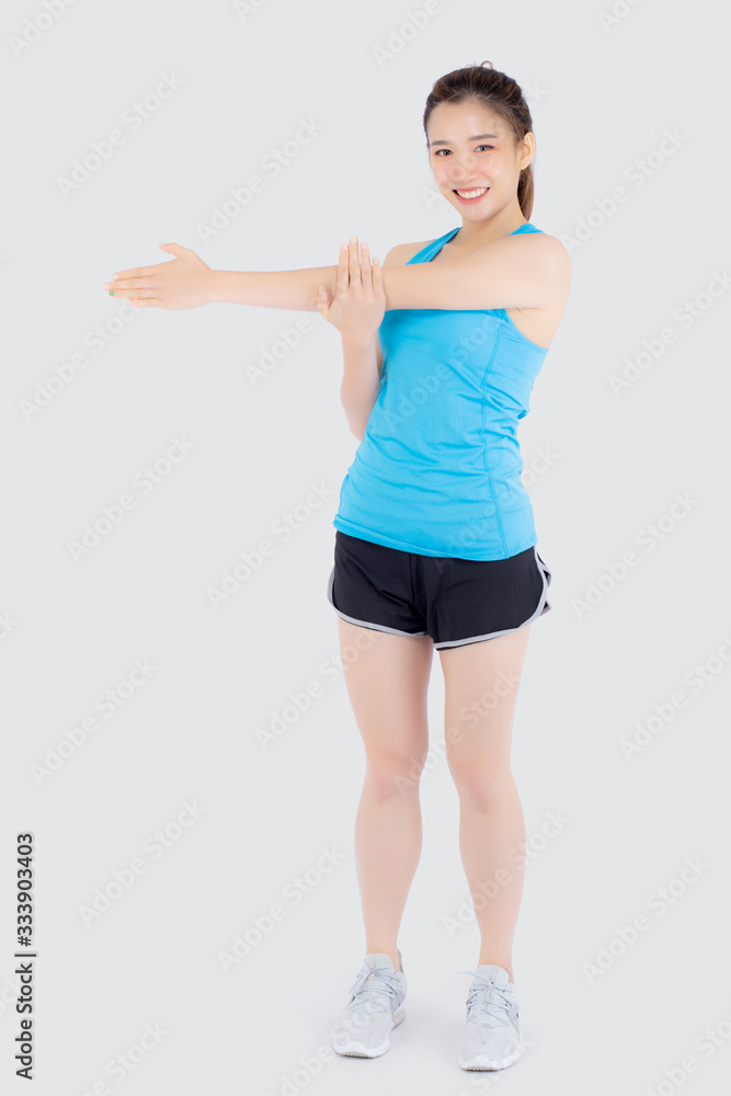 Beautiful portrait young asian woman happy standing stretch muscle arm isolated on white background, girl wear sport clothes smiling exercise yoga for health, healthy and wellness concept. Beautiful portrait young asian woman happy standing stretch muscle arm isolated on white background, girl wear sport clothes smiling exercise yoga for health, healthy and wellness concept.