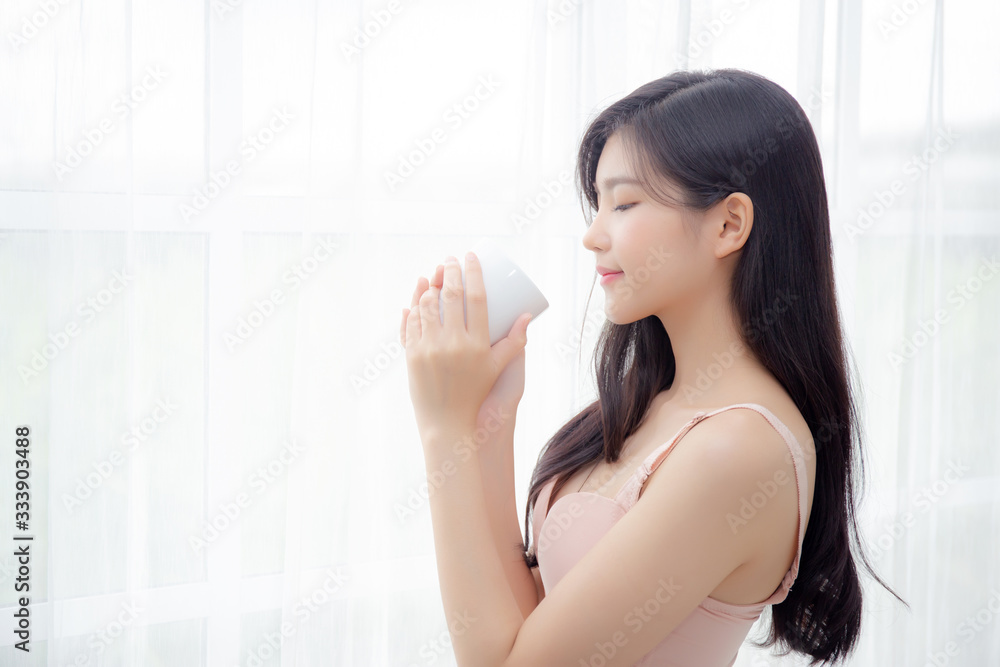 Beautiful young asian sexy woman in underwear drinking coffee near windows in the morning, girl with seductive figure fit drinking beverage for relax and resting after wake up, lifestyle concept. Beautiful young asian sexy woman in underwear drinking coffee near windows in the morning, girl with seductive figure fit drinking beverage for relax and resting after wake up, lifestyle concept.