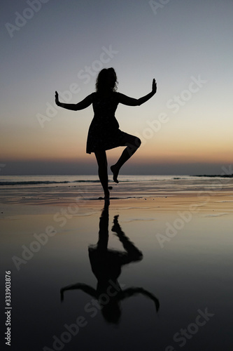 yoga at the sunset on the beach