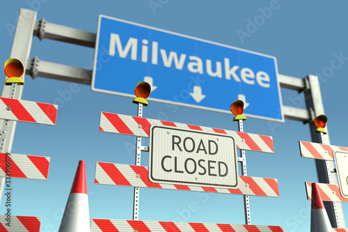 Road barricades near Milwaukee city road sign. Lockdown in the United States conceptual 3D rendering © Alexey Novikov