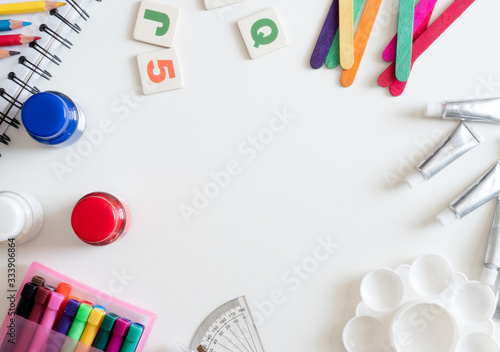 Back to school concept and artist kid concept with Drawing book, crayons, coloured pencils, Poster color and School stationery on white wooden background.