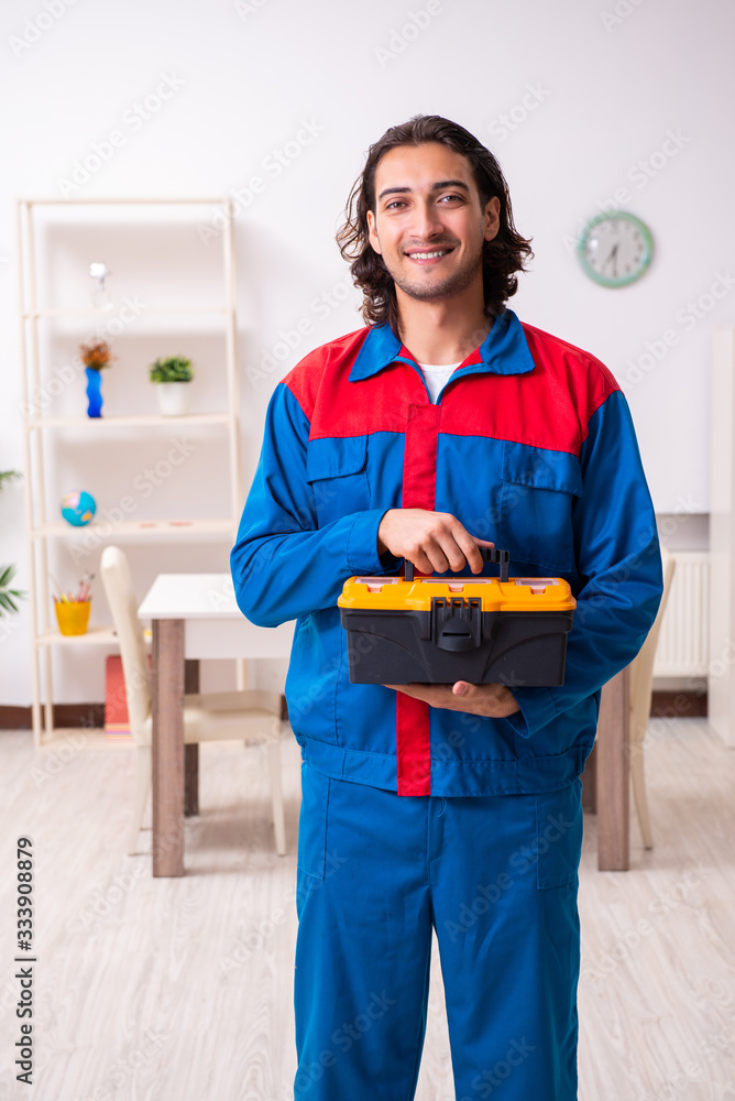 Young male carpenter working indoors Young male carpenter working indoors