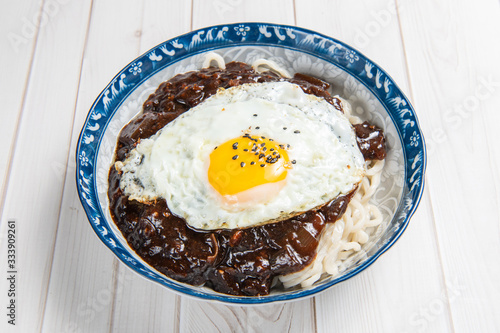 Jajangmyeon or jjajangmyeon is a Korean-style Chinese noodle dish topped with a thick sauce made of chunjang, photo