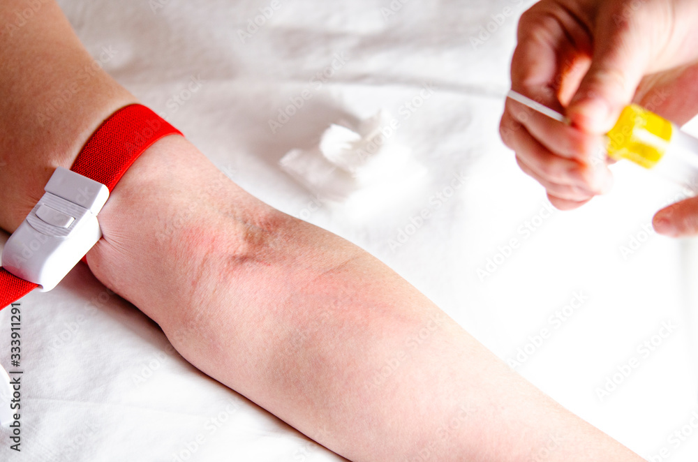 A woman's hand when hooked to intravenous infection and blood test A woman's hand when hooked to intravenous infection and blood test