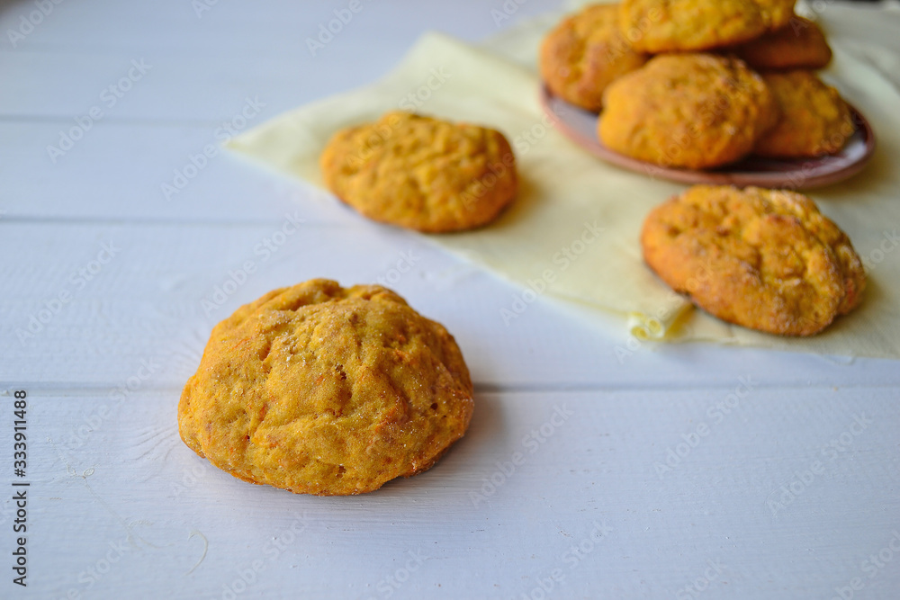 Home made carrot cookies on a white kitchen table. Home made carrot cookies on a white kitchen table.