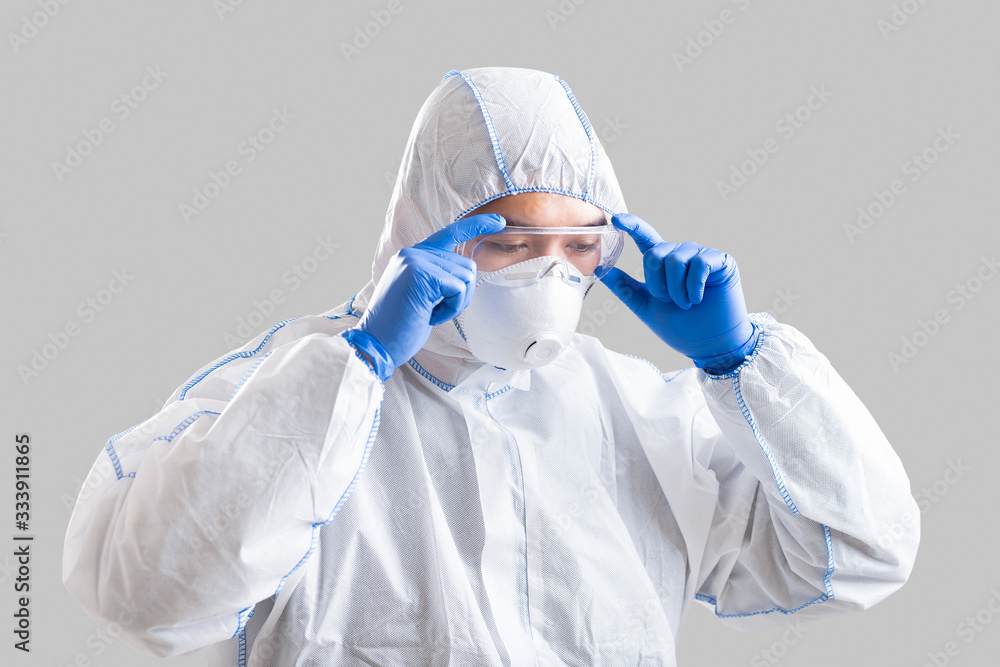 Epidemic prevention concept. Asian man puts on protective suit Epidemic prevention concept. Asian man puts on protective suit